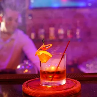 a glass of cocktail on the bar