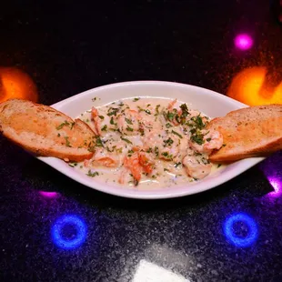 a bowl of seafood and bread