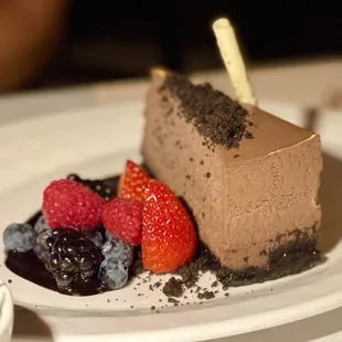 a slice of chocolate cheesecake with berries