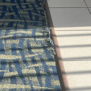 Carpet worn and ripping up.