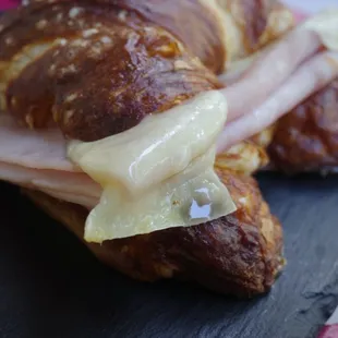 Pretzel croissant, breakfast sandwich with ham and Swiss cheese with a hint of yellow mustard so delicious
