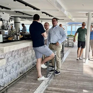 a group of men sitting at a bar