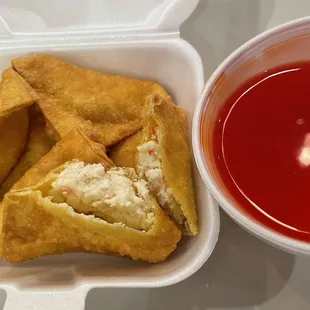 a bowl of ketchup and a plate of fried food