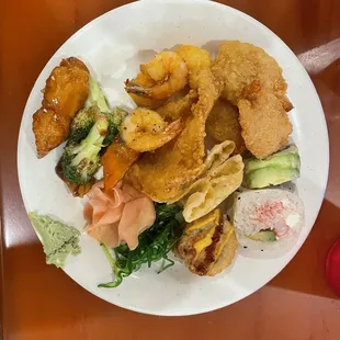 Variety of Seafood ( fish,shrimp) with chicken and Sushi.