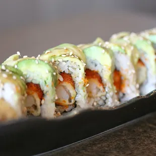 Grinch Roll (In: Masago, Shrimp Tempura; Out: Avocado; Sauce: Eel