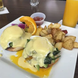 Eggs Benedict, potatoes, orange juice