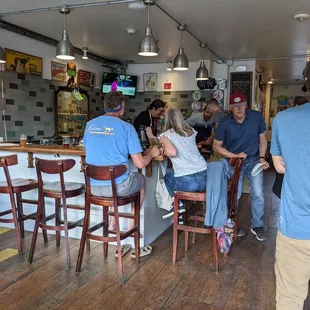a group of people sitting at a bar