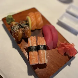 a plate of sushi and rolls