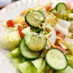a salad with cucumbers and tomatoes