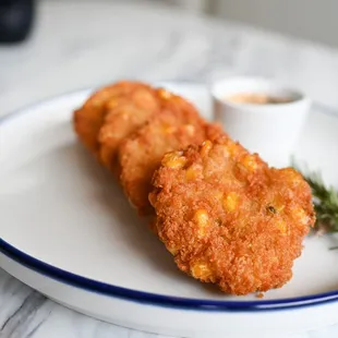 two fried fish cakes on a plate