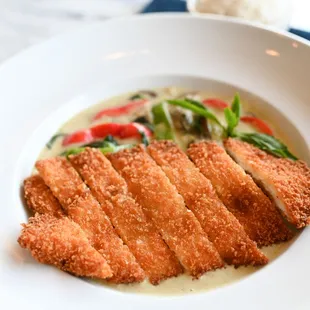 a plate of fish with vegetables