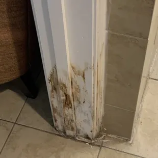 Unknown brown stains on the bathroom doorframe.