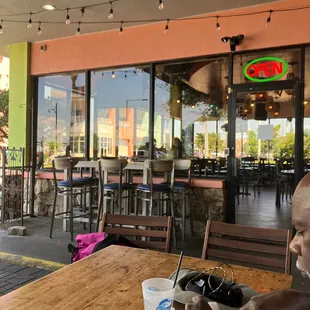 a man sitting at a table outside a restaurant