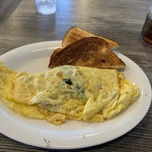 Sausage and spinach omelette with toast.
