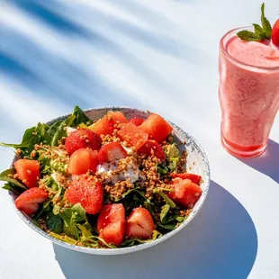 a bowl of salad and a glass of smoothie