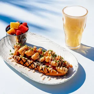 a plate of food and a glass of beer