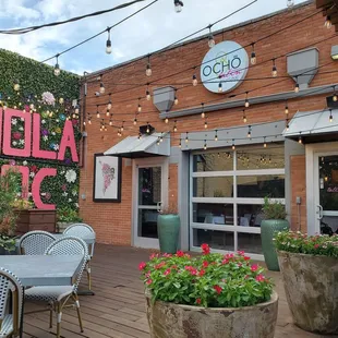 a patio with tables and chairs