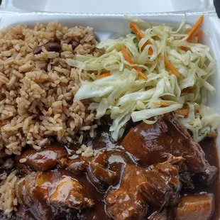 Brown stew chicken. Fried cabbage. Rice and pea