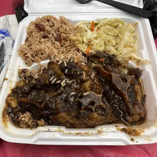 a styrofoam container with rice and meat