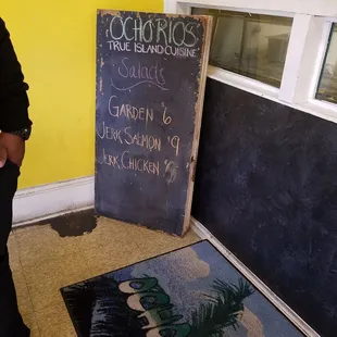 a man standing in front of a chalkboard