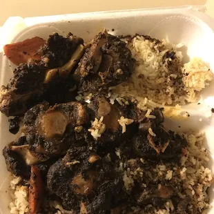 rice, meat, and vegetables in a styrofoam container