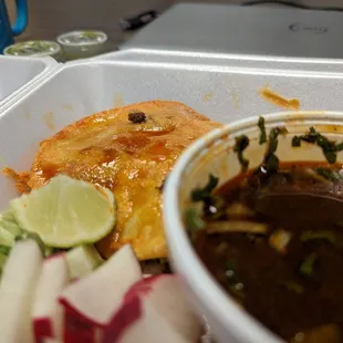 a close up of a meal in a styrofoam container