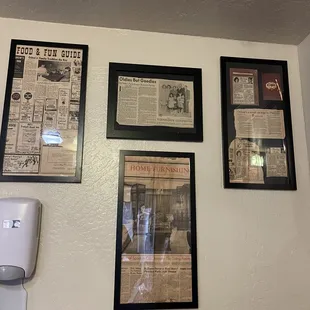 a collection of newspapers on the wall