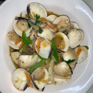 a white plate of clams and vegetables