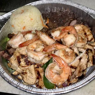 shrimp and rice in a foil container
