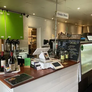 a counter with wine bottles and a menu