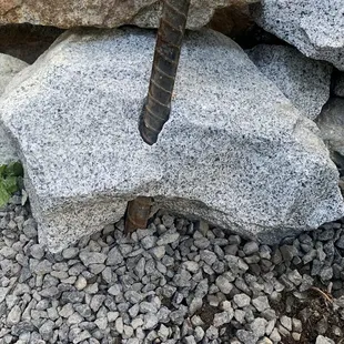 Drilled out granite and placed rebar through hole and down 3&apos; deep.