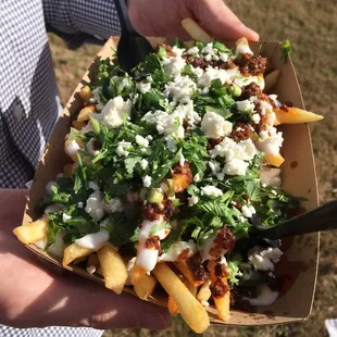 Lamb chorizo fries topped with feta and cilantro. Drool...