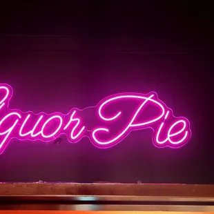 a neon sign that reads liquor pie