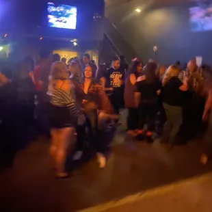 a crowd of people dancing in a nightclub