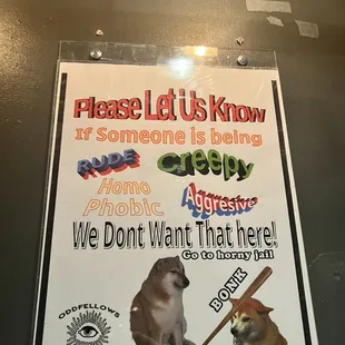 a sign with a dog and a baseball bat
