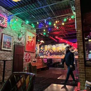 a man walking through the bar