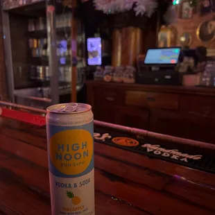 a can of beer on a bar