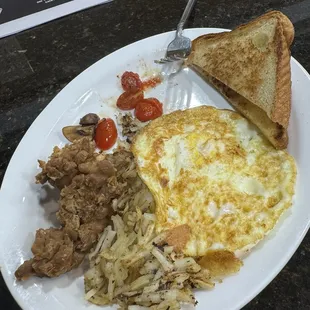 Eggs, grilled tomato, saute mushroom, wierdly   unrecognizable sweet baked beans, burnt hashbrown and artisan Toast.