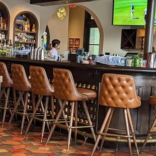 a row of leather bar stools