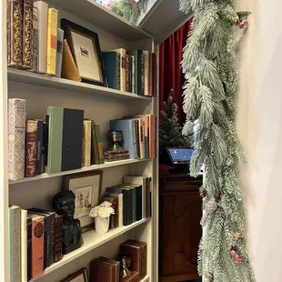 a bookshelf with christmas decorations