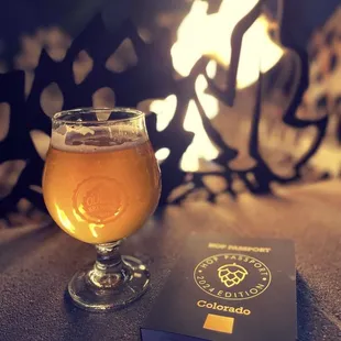 a glass of beer and a passport