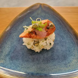 a plate of sushi on a wooden table
