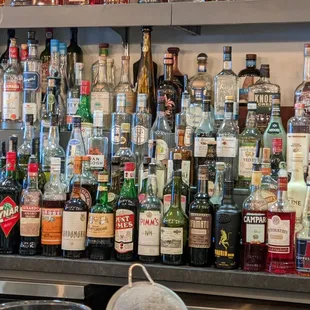 a shelf full of liquor bottles