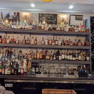 a bar with shelves full of liquor bottles