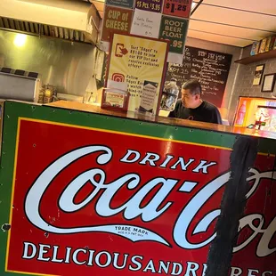 a man behind the counter of a restaurant