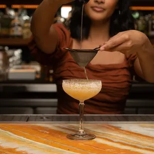 a woman making a drink