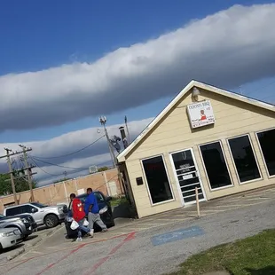 ows a group of people sitting outside of a building