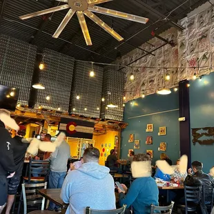 people sitting at tables in a restaurant
