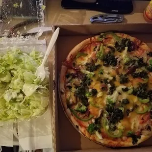 Veggie pizza and a half-eaten Greek salad (to show the size and freshness of the ingredients).