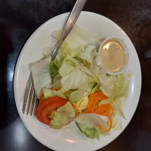 a plate of salad with dressing